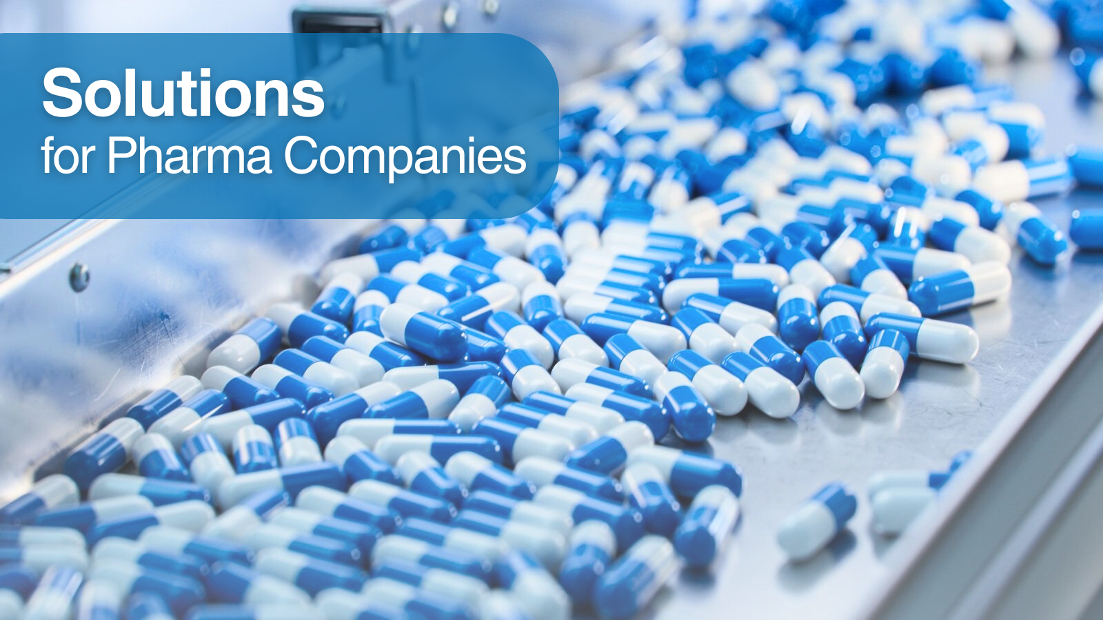 A set of pills in a pharmaceutical manufacturing plant. Top left, a text that reads Solutions for Pharma Companies.